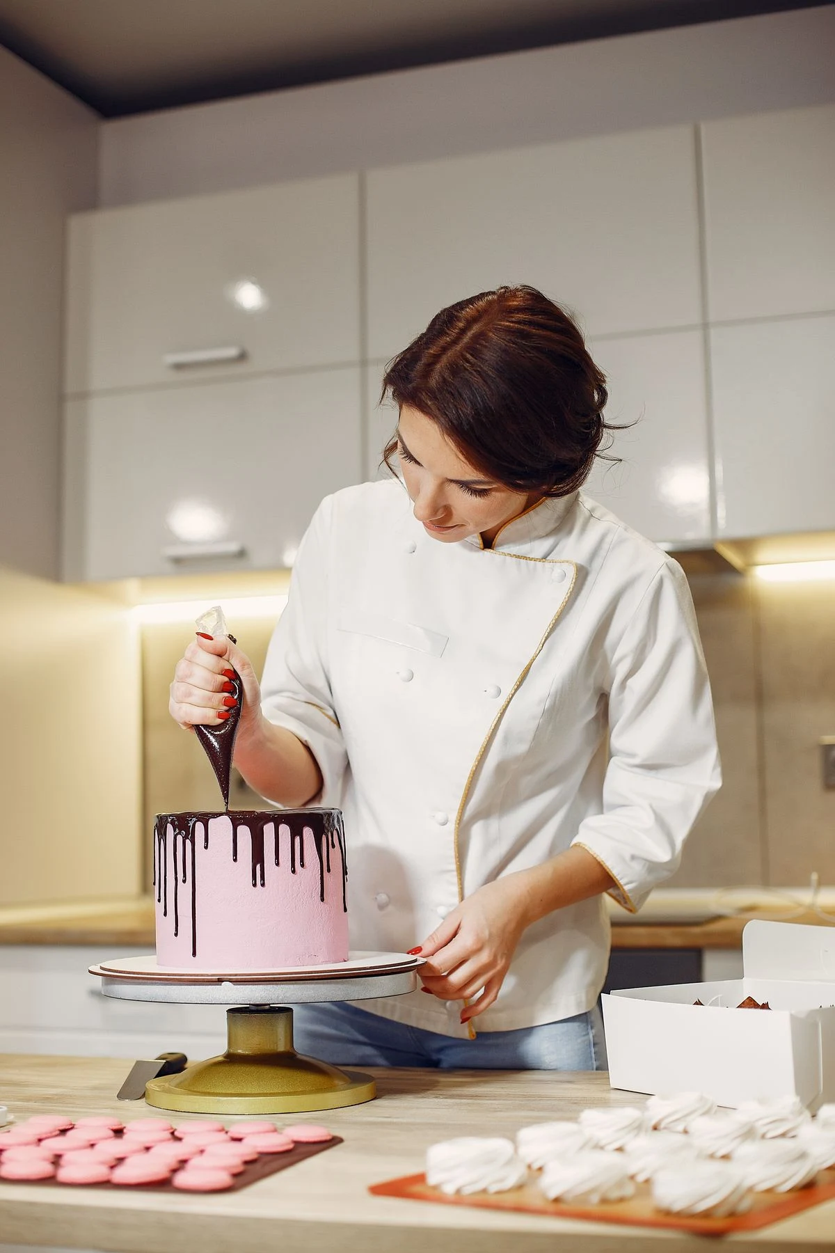 Cake designer finishing a cake