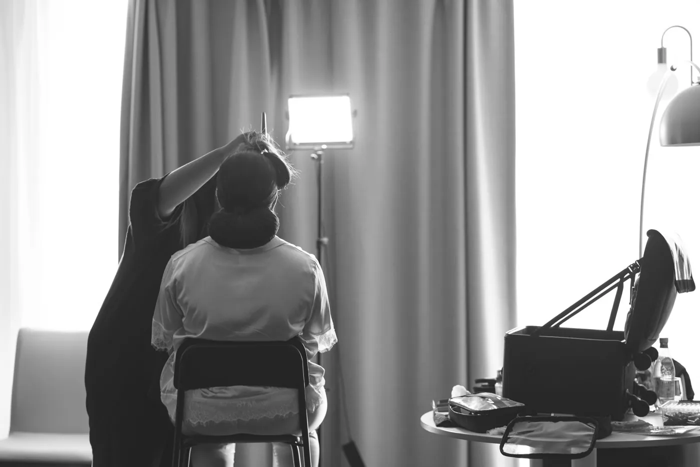 A bride getting her hair styled by a professional before the wedding ceremony. Licensed inspiration image; not a BMG client portfolio claim.